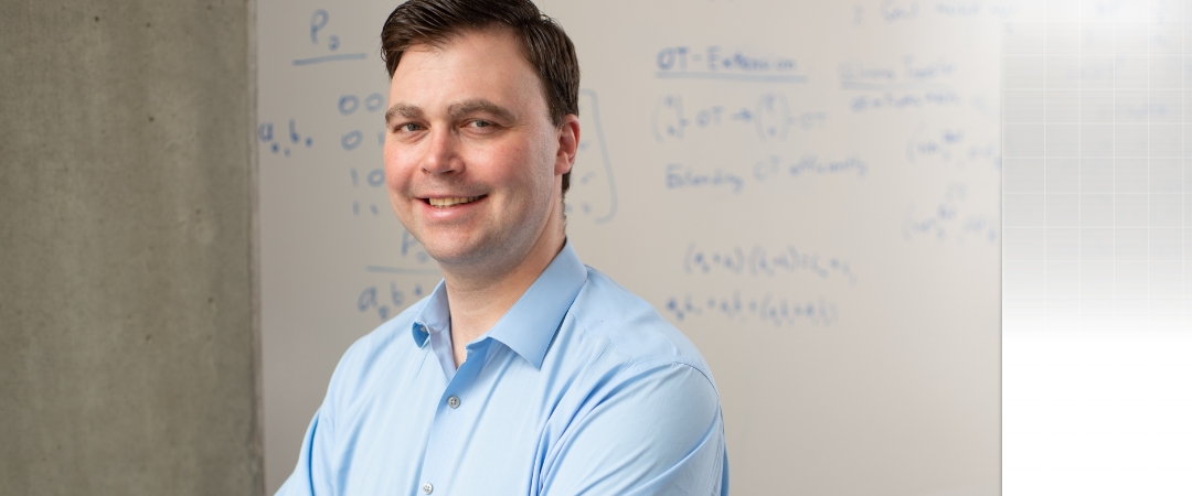 Professor standing and smiling