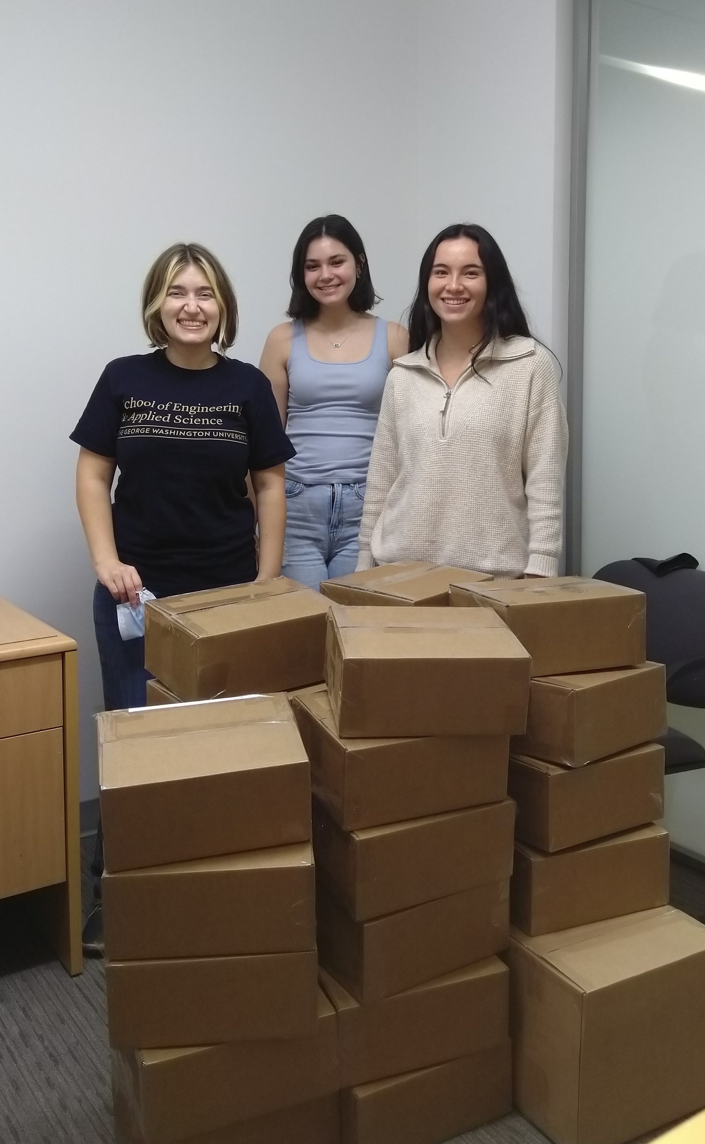 Elyse Nicolas, Lauren Schmidt, and Catherine Meadows with post-camp boxes