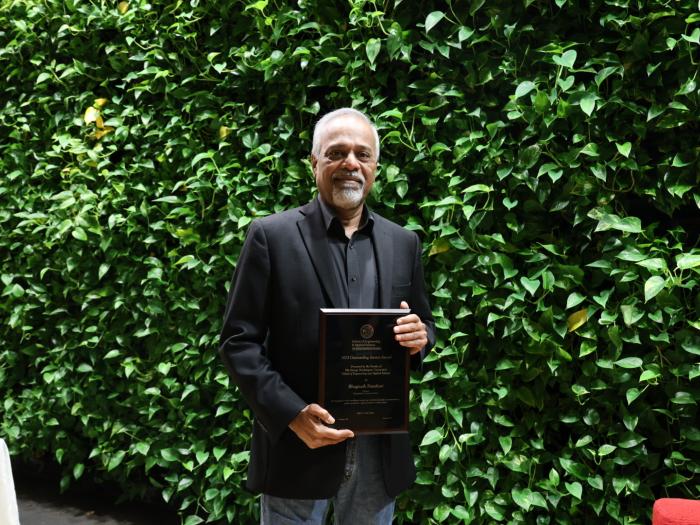 Professor Narahari holding his award plaque