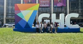 Computer Science undergraduate students posing in front of the GHC sign