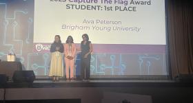 Ilakkiya Vijayakumar (middle) pictured on stage alongside the competition's first place winner, Ava Peterson.